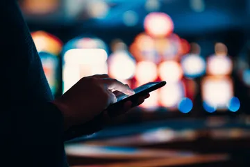 A stylish woman beside vibrant slot machines displaying glowing sevens, showcasing the variety of top slots at 9777.