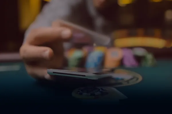 A person using their device against a moody casino-themed background, illustrating the smooth re-entry process at 9777.